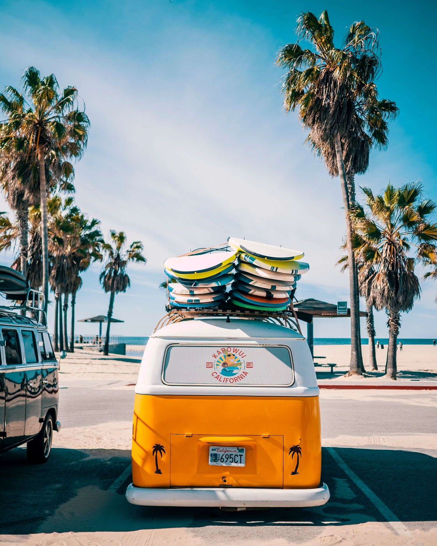 A van with surf boards on top.