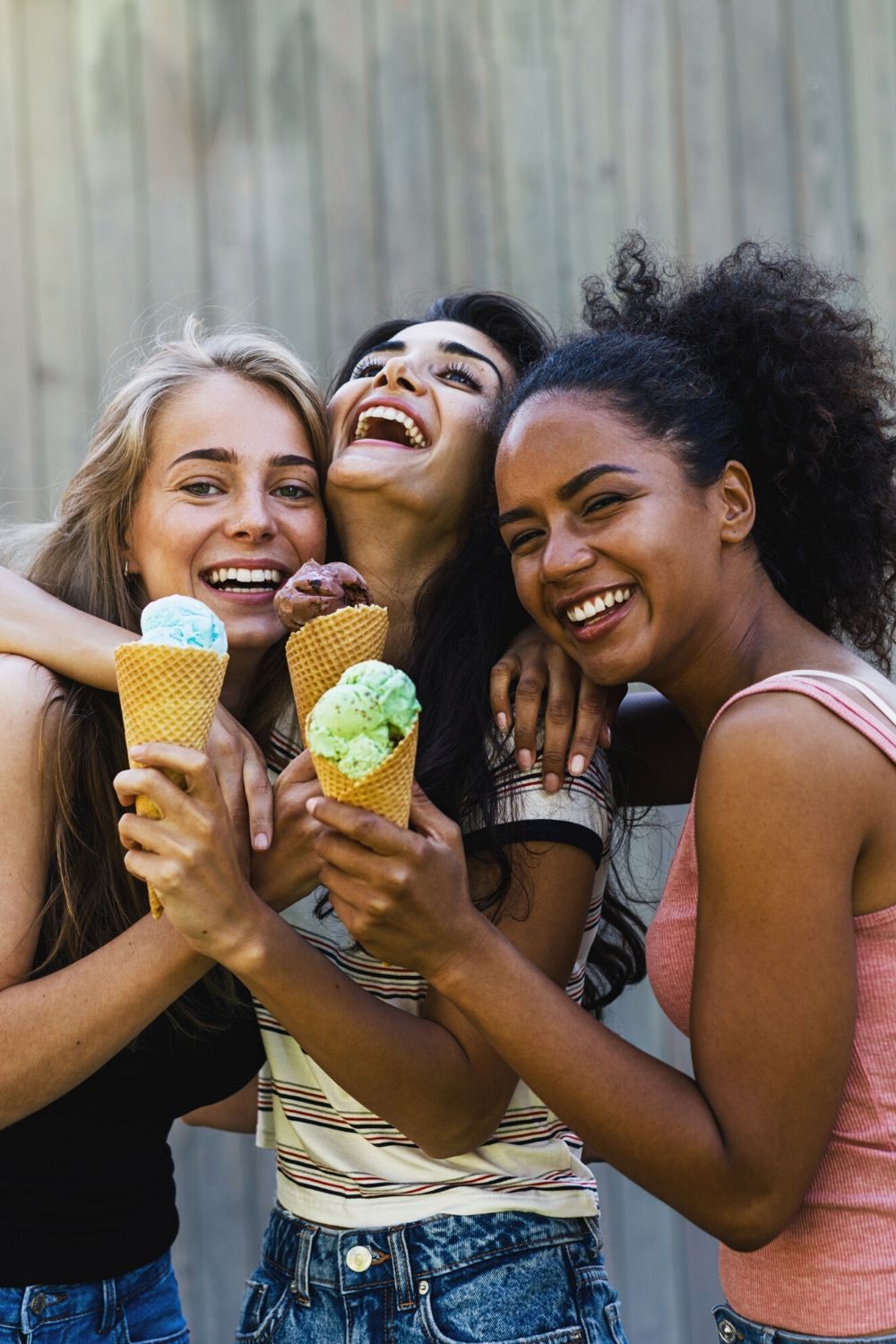 Three friends sharing ice cream.