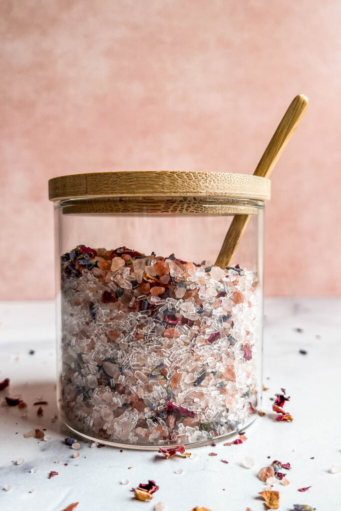 A DIY rose lavender bath soak in a glass jar.